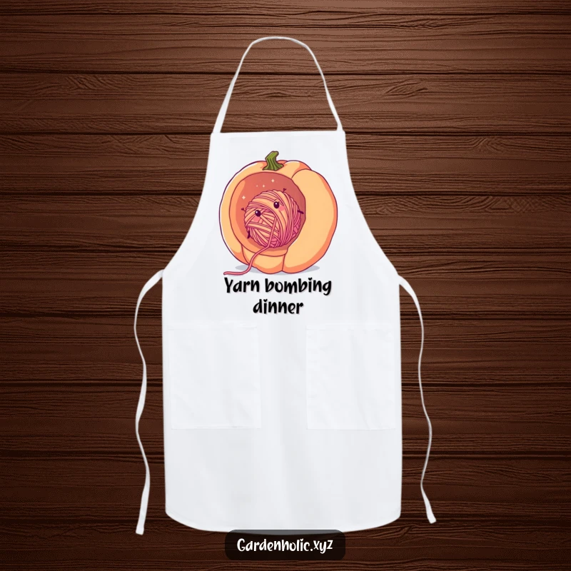 Funny yarn crafter apron showing a cheerful, fuzzy ball of yarn rolling inside a giant pumpkin, adding crafting humor.