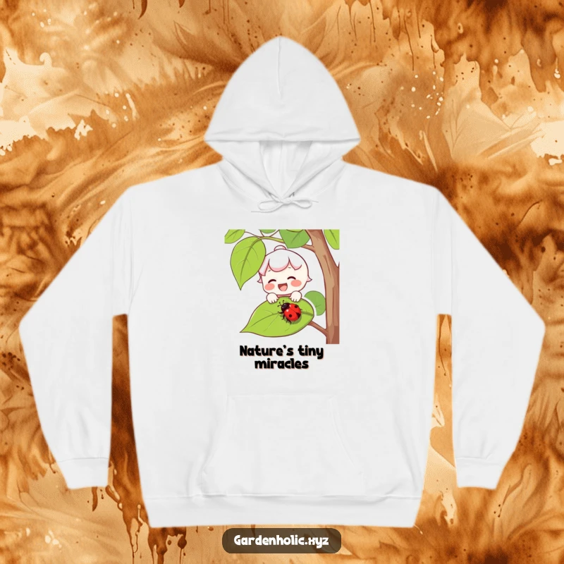 Funny hoodie depicting a joyful character with rosy cheeks delicately catching a falling ladybug on a leaf.
