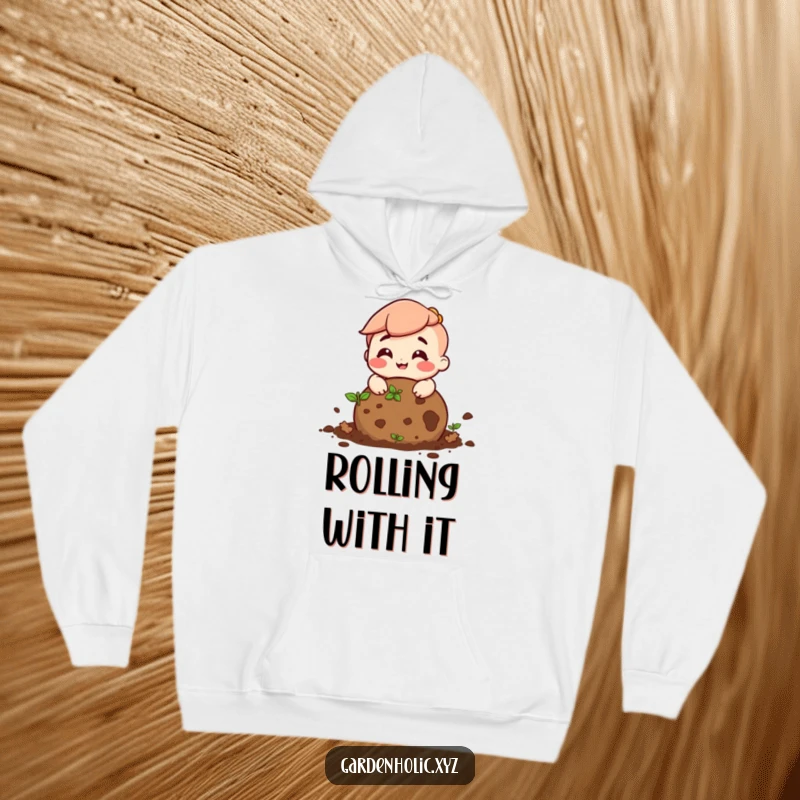 Funny hoodie featuring a character with a big smile rolling a ball of soil, perfect for earthy enthusiasts.